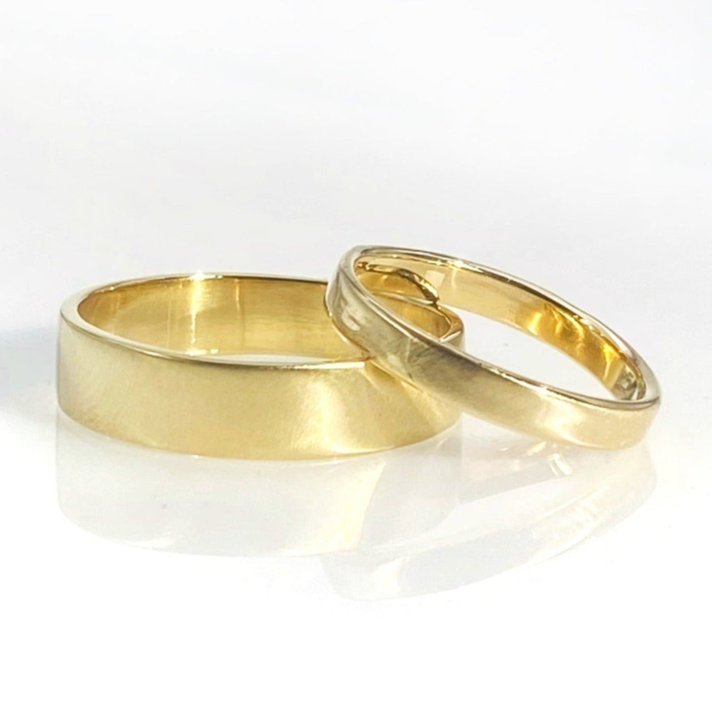 Two rings, one larger and one smaller, with a matte brushed finish, on a white background.