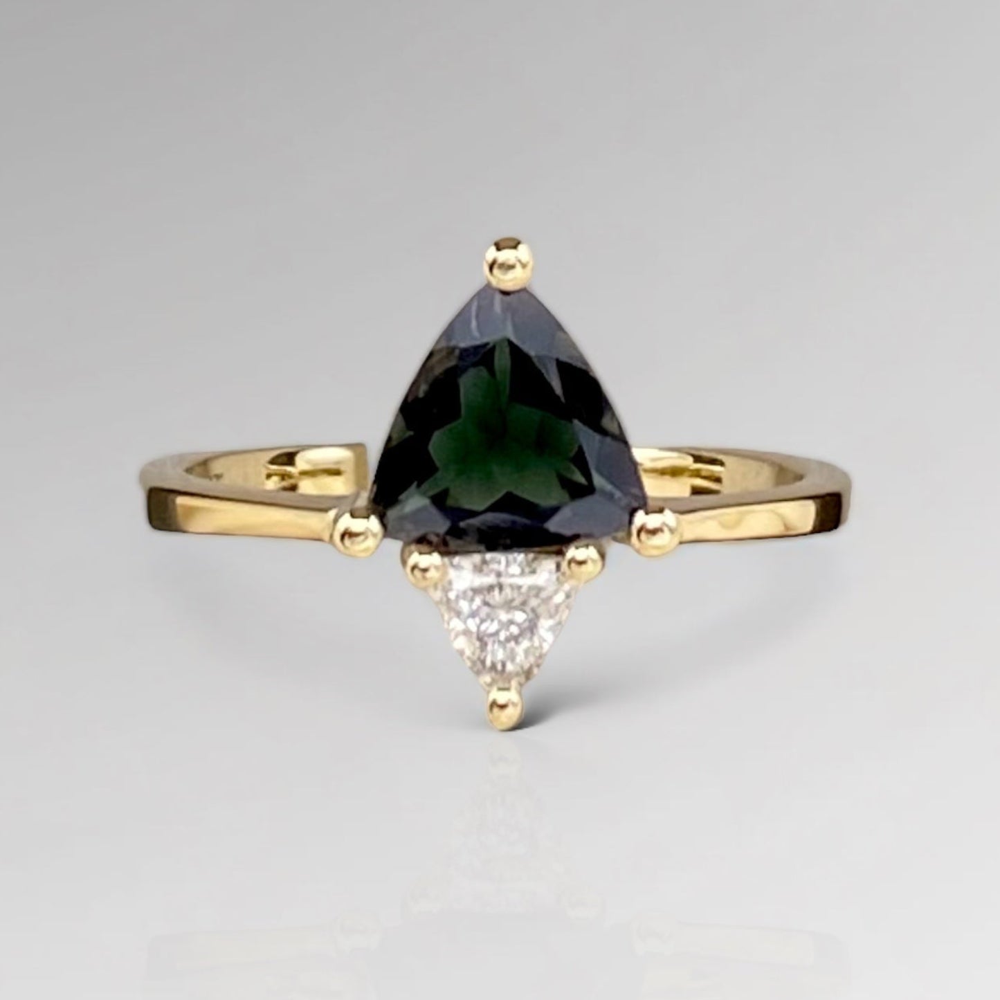 A 14k solid gold ring with a green tourmaline triangle stone and a white natural triangle diamond