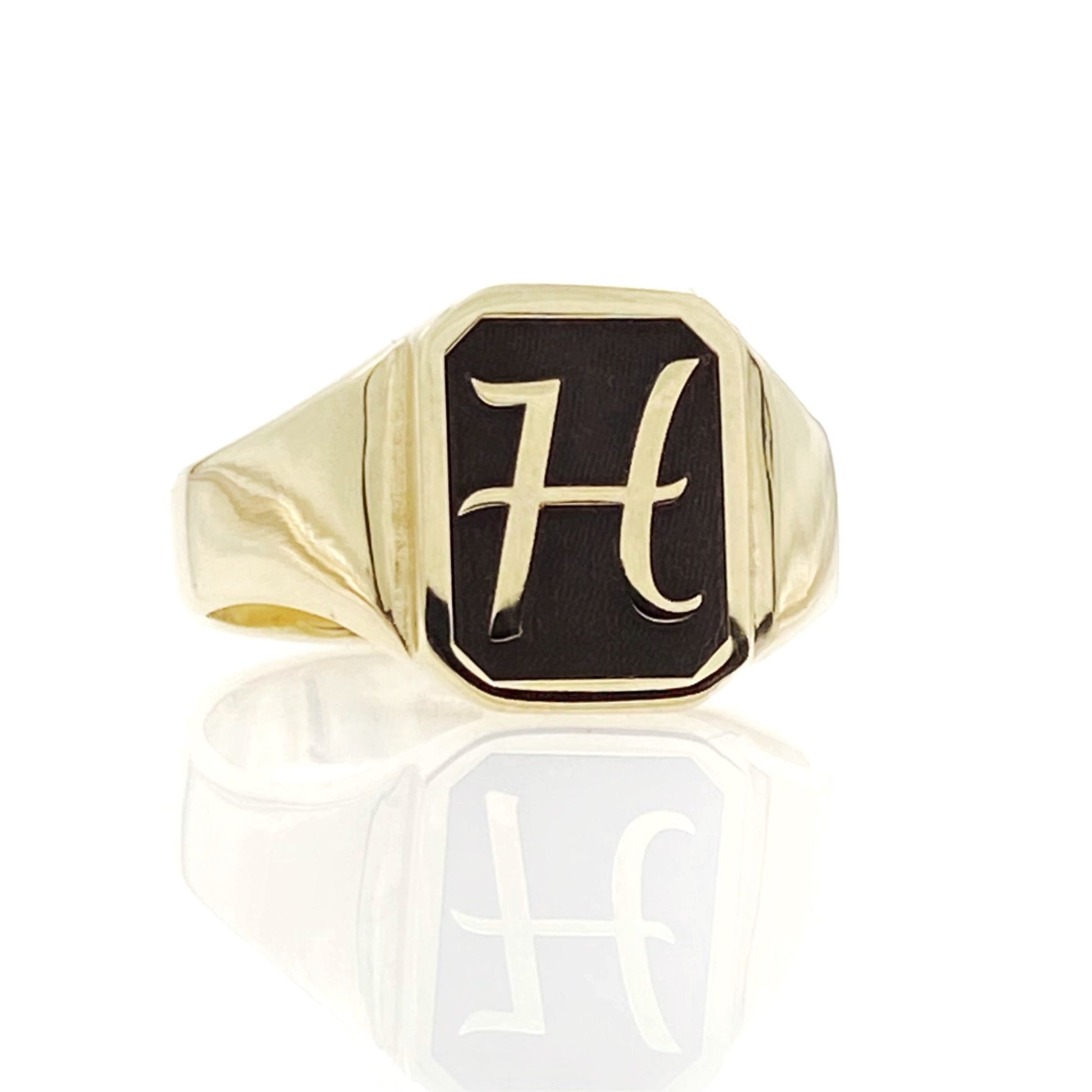 A gold initial octagon signet ring with the letter 'H' engraved on it, displayed against a white background.