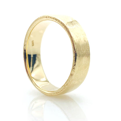 A textured gold wedding ring with a polished finish.