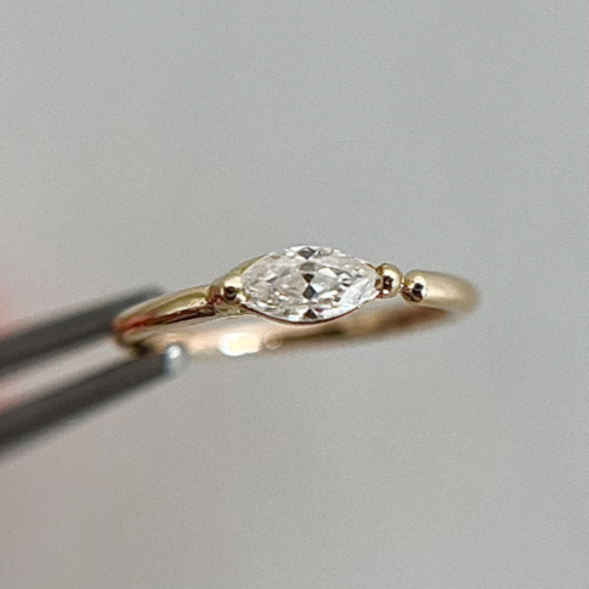 gold helix piercing ring with a diamond or moissanite stone.