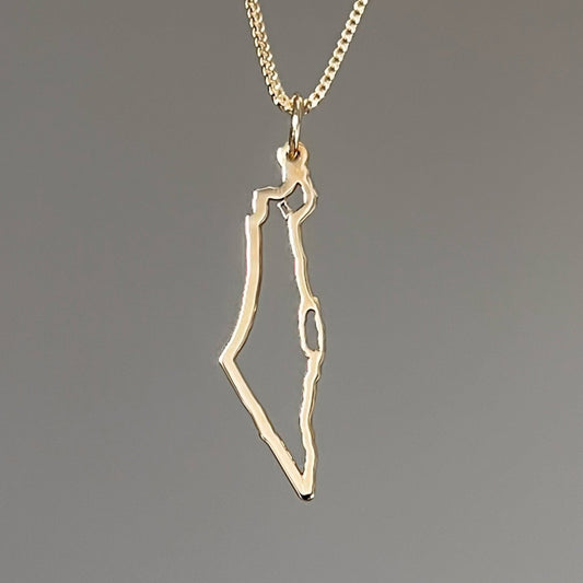A gold necklace with a pendant in the shape of Israel map outline