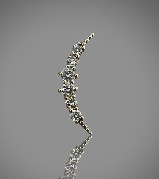 moon-shaped stud earring made of 14k solid gold with natural diamonds, against a grey background.