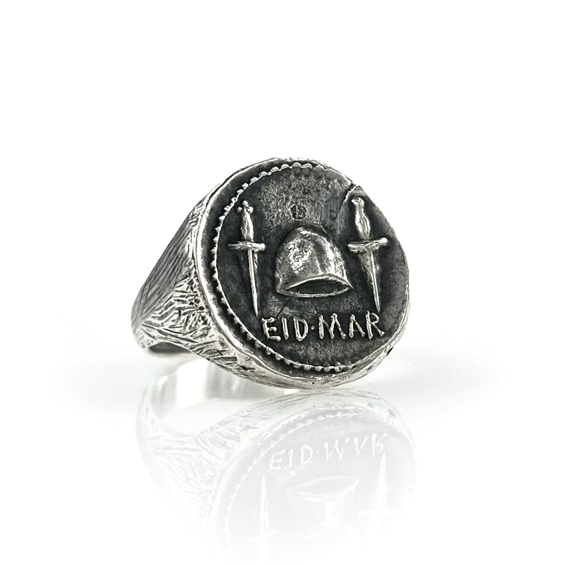 A 925 sterling silver signet coin ring with engraved designs and the text 'EID MAR'.