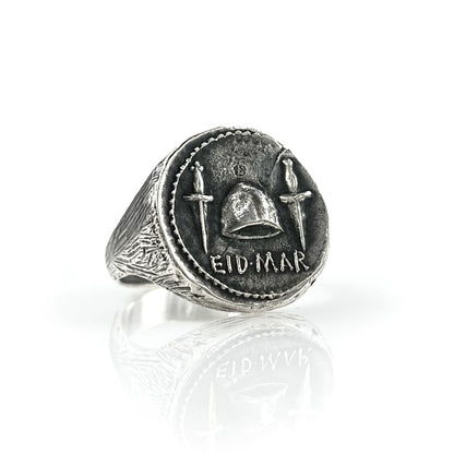 A 925 sterling silver signet coin ring with engraved designs and the text 'EID MAR'.