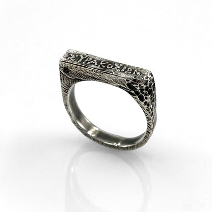A 925 sterling silver square ring with raw texture and a handcrafted minimalist design.