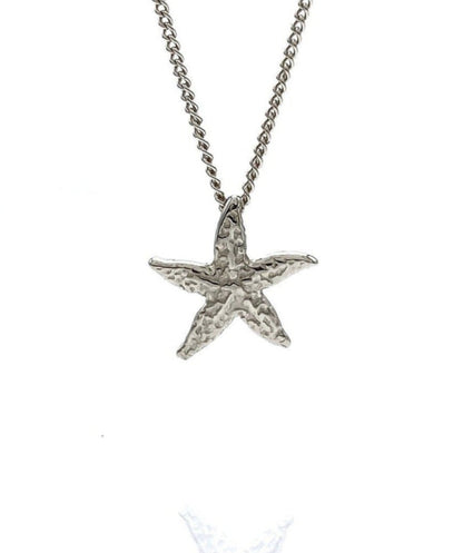 A 14k solid gold starfish pendant necklace on a curb chain.