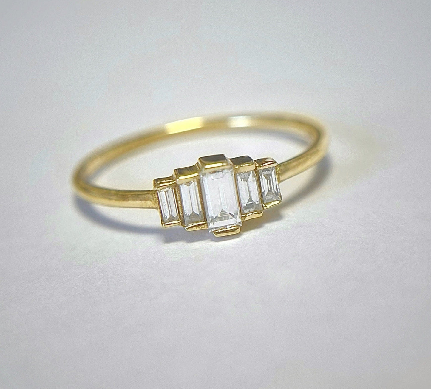 A degrade baguette diamond ring set in 14K gold, displayed against a white background.