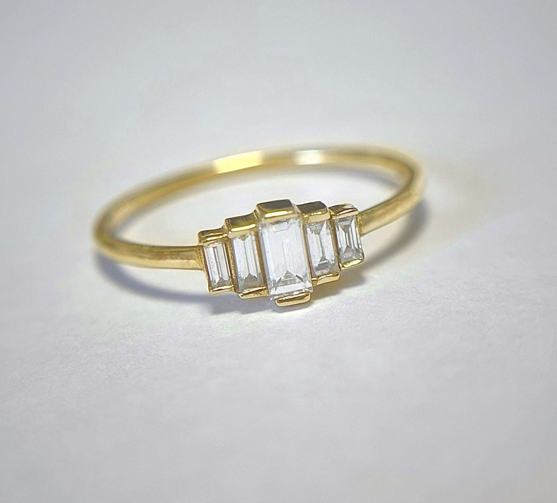 A degrade baguette diamond ring set in 14K gold, displayed against a white background.