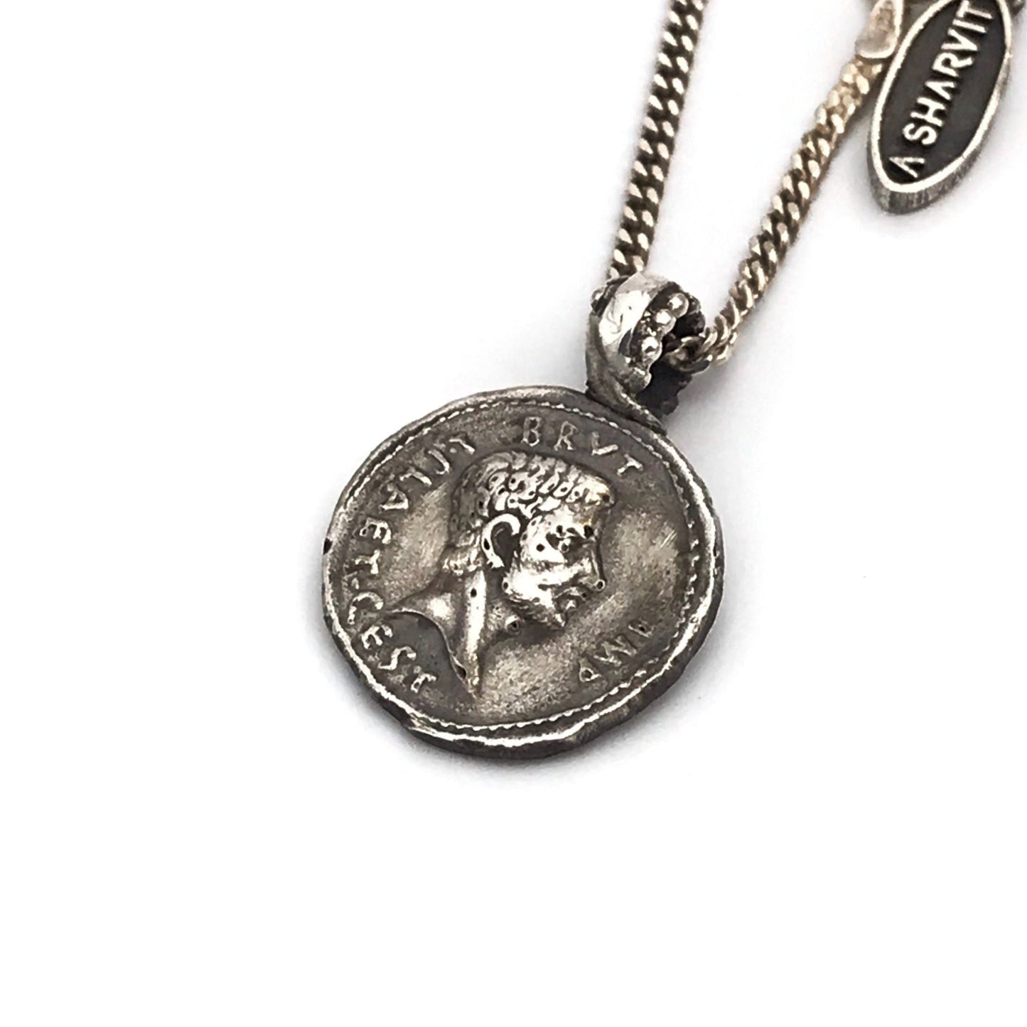 An ancient caesar coin silver necklace with a shiny rustic finish, featuring a silver chain and a coin pendant.