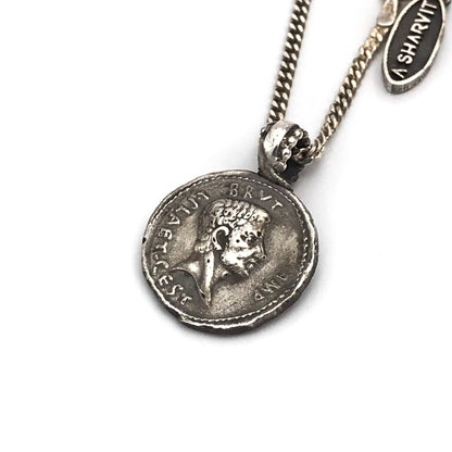 An ancient caesar coin silver necklace with a shiny rustic finish, featuring a silver chain and a coin pendant.
