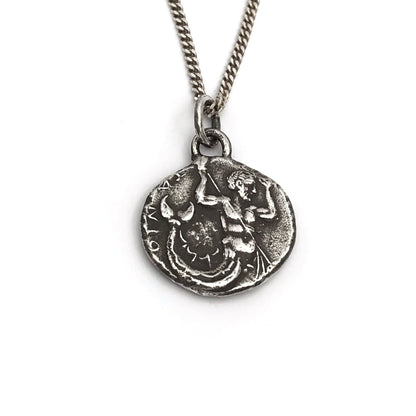 A silver necklace featuring a vintage style Poseidon coin pendant