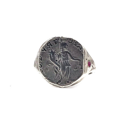 A sterling silver ring with an engraved ancient coin and a red ruby stone