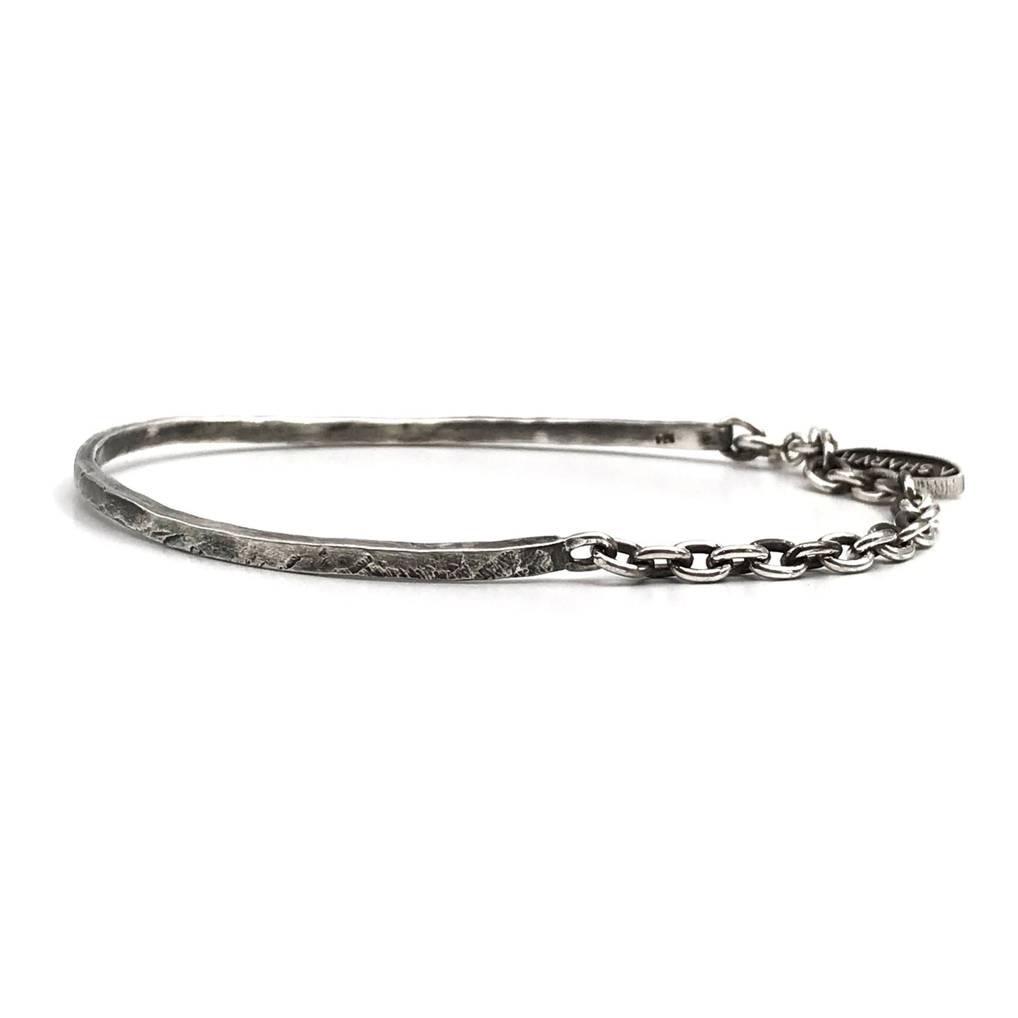 A sterling silver cuff bracelet with a combination of oxidized and polished finishes, giving it a rugged and realistic appearance.