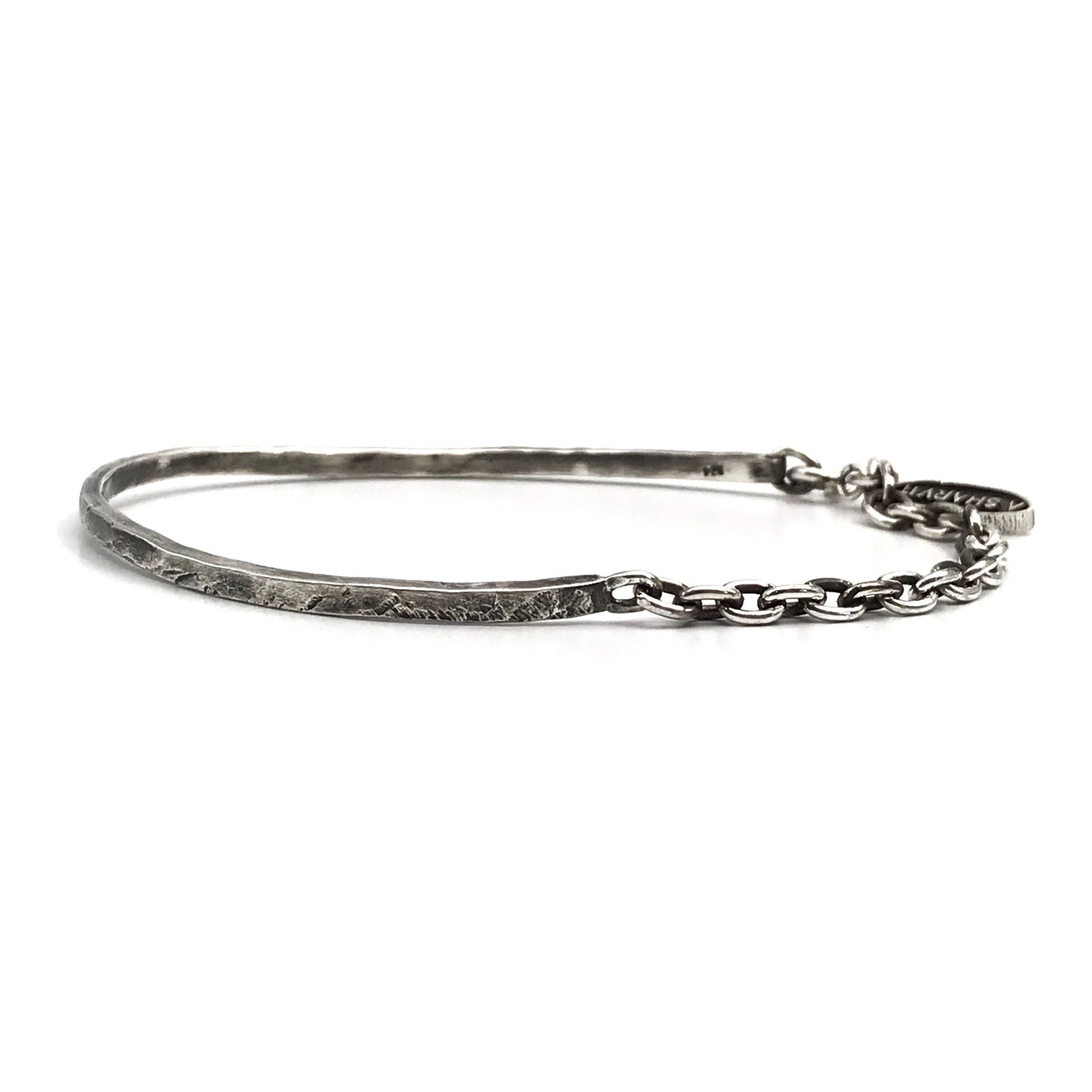 A sterling silver cuff bracelet with a combination of oxidized and polished finishes, giving it a rugged and realistic appearance.