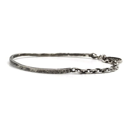 A sterling silver cuff bracelet with a combination of oxidized and polished finishes, giving it a rugged and realistic appearance.